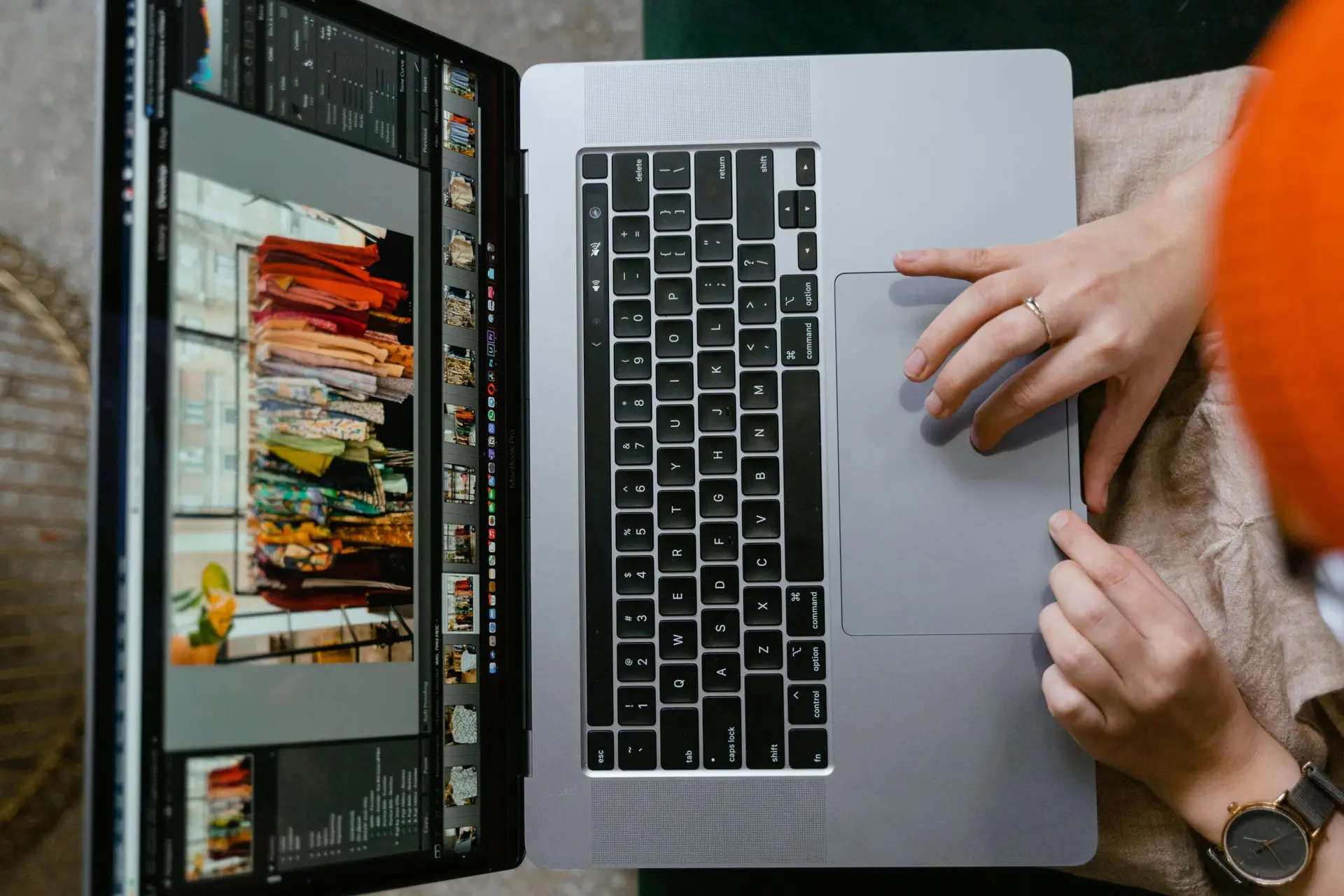 Top view of hands using a laptop showing online fashion shopping platform, highlighting technology and connectivity.